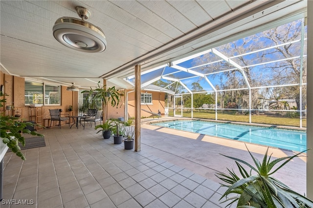 view of pool featuring a patio, a lanai, and ceiling fan