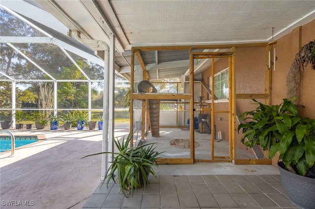 view of patio / terrace featuring glass enclosure and an outdoor pool