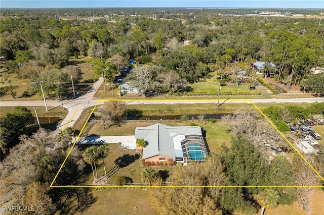 birds eye view of property with a view of trees