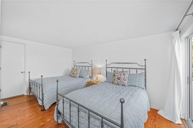 bedroom with hardwood / wood-style floors