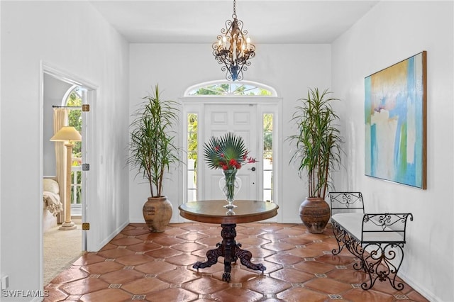 entryway with a chandelier