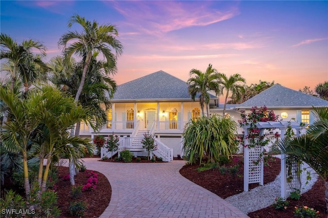 view of front of home with a porch and a pergola