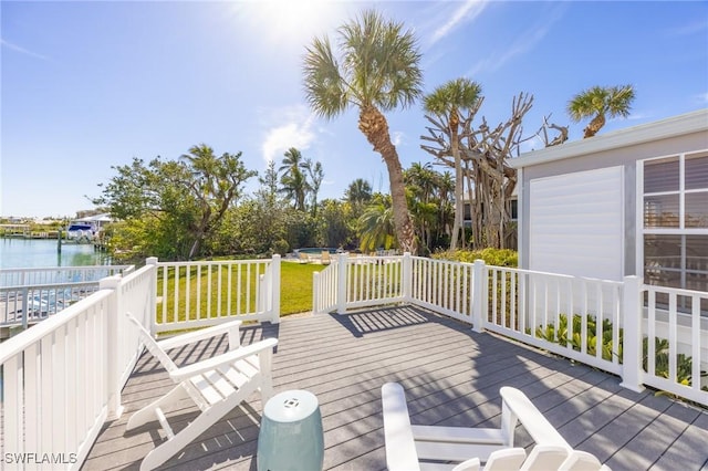 deck featuring a yard and a water view