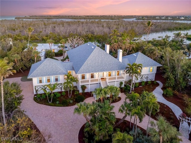 aerial view at dusk with a water view