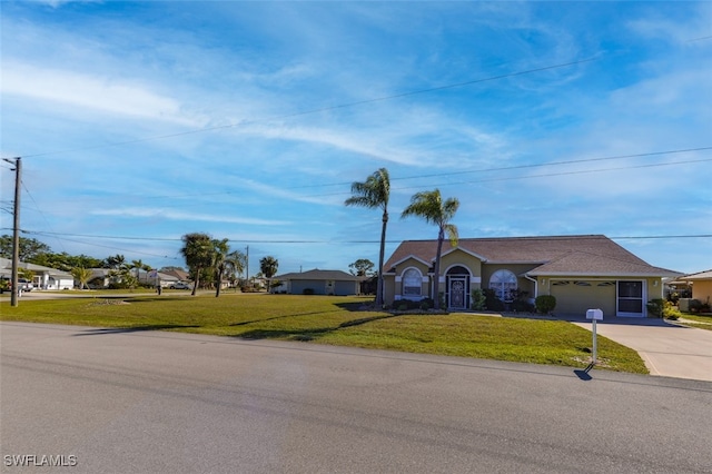 ranch-style home featuring a garage and a front yard