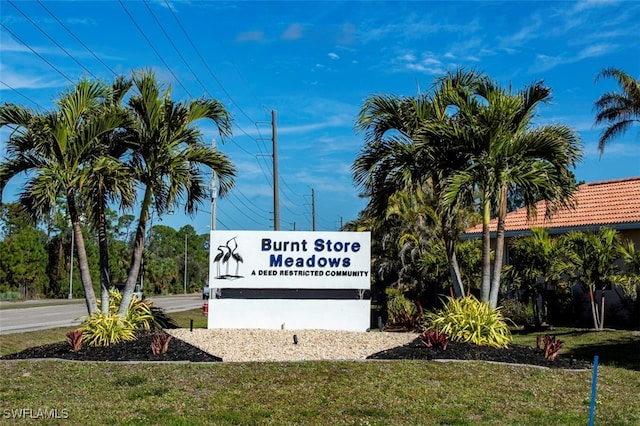 community / neighborhood sign with a lawn