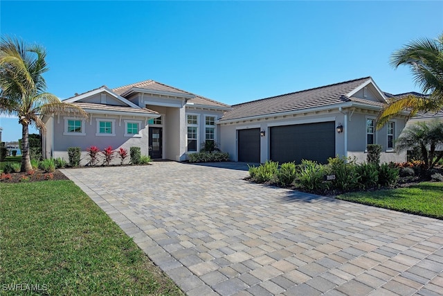 view of front of home featuring a garage and a front lawn