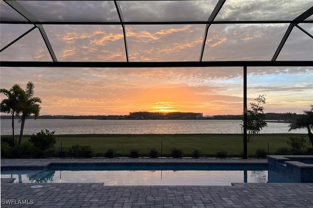 pool at dusk with a water view and glass enclosure