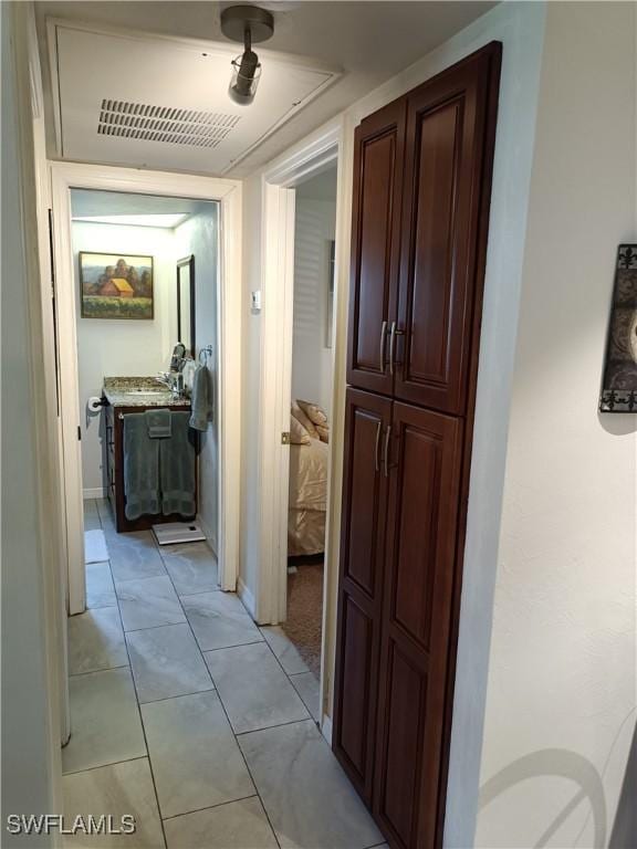 hallway featuring light tile patterned floors