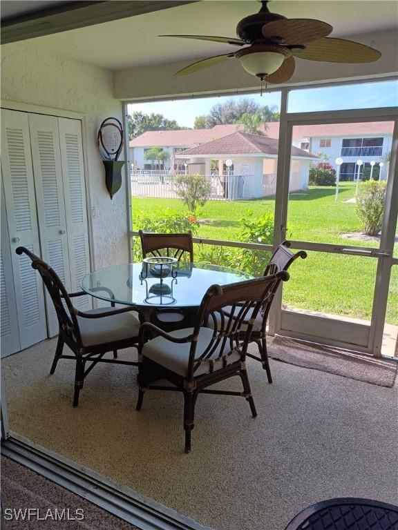 sunroom / solarium featuring ceiling fan