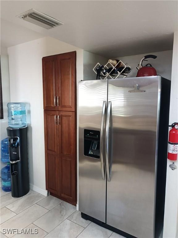 kitchen with stainless steel refrigerator with ice dispenser