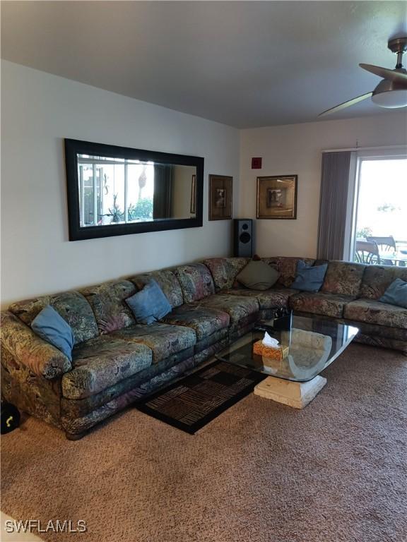 living room featuring ceiling fan and carpet flooring