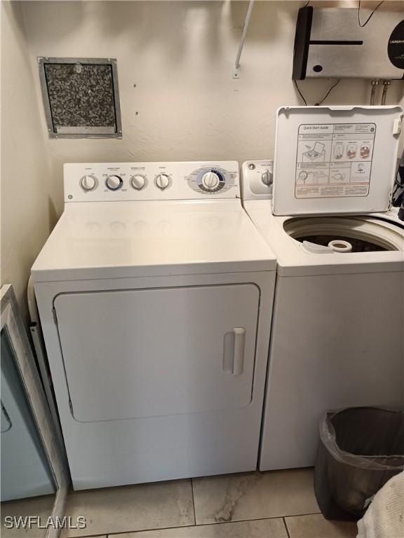 clothes washing area with separate washer and dryer