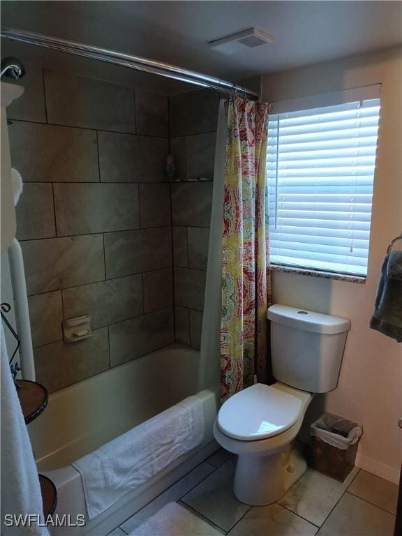 bathroom featuring shower / bath combo, tile patterned floors, and toilet