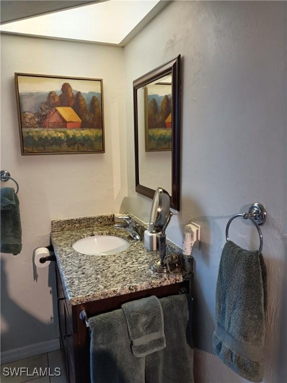 bathroom with vanity and a skylight