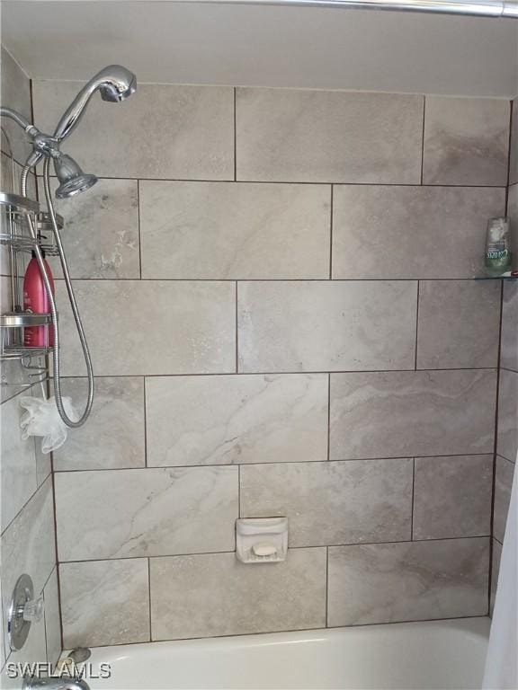 interior details featuring shower / tub combo