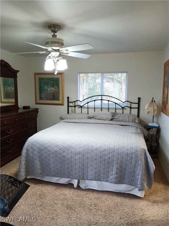 bedroom with ceiling fan and carpet