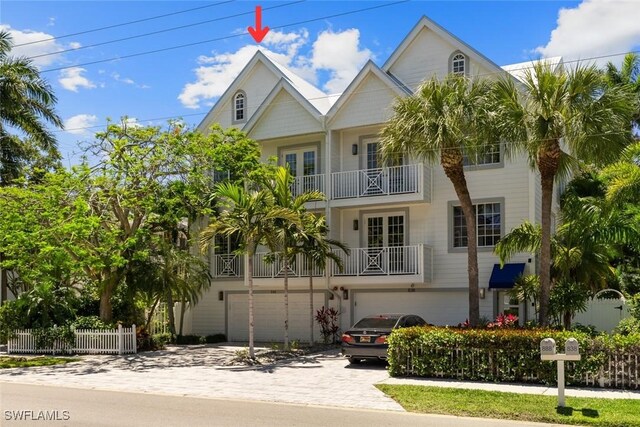 view of front of property featuring a garage and a balcony