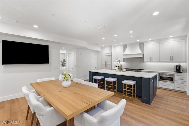 dining room featuring sink and light hardwood / wood-style flooring