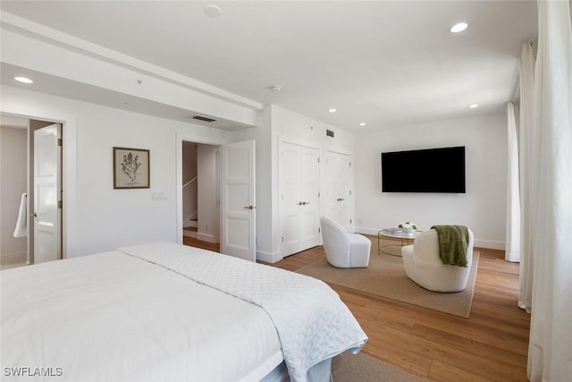 bedroom with wood-type flooring and a closet