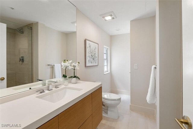 bathroom featuring vanity, a shower with shower door, tile patterned floors, and toilet