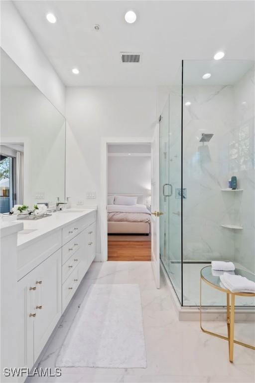 bathroom featuring vanity and a shower with shower door