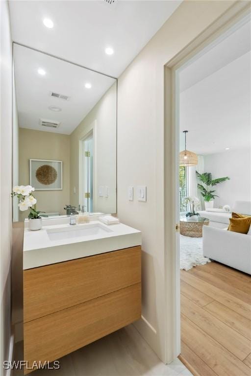 bathroom featuring hardwood / wood-style flooring and vanity