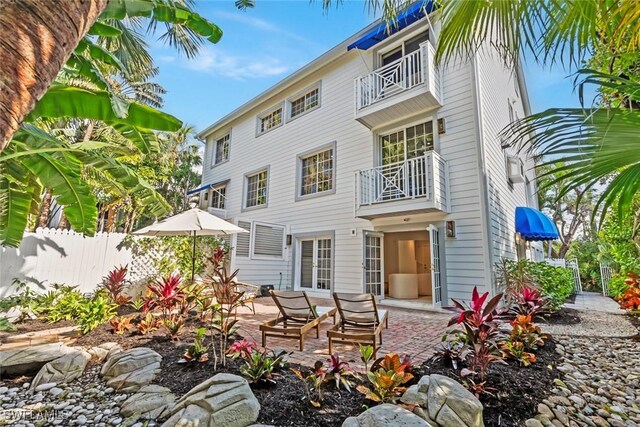 rear view of house with a balcony and a patio area