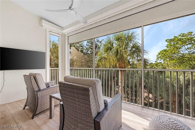 sunroom featuring ceiling fan