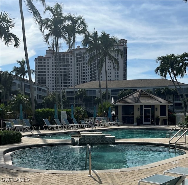 community pool featuring fence and a patio