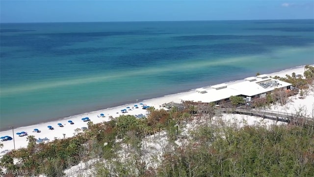 drone / aerial view featuring a water view and a view of the beach