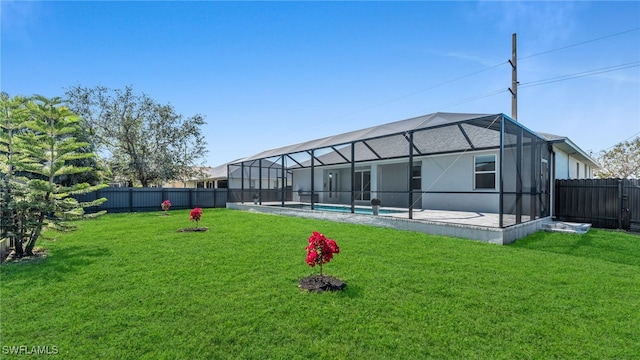 back of property featuring a fenced in pool, glass enclosure, a fenced backyard, and a yard