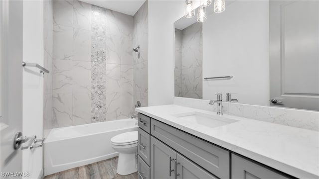 full bath featuring toilet, shower / tub combination, wood finished floors, and vanity