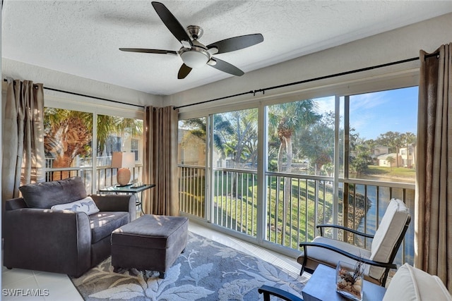 sunroom / solarium featuring a wealth of natural light and ceiling fan