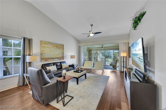 living room with hardwood / wood-style flooring, high vaulted ceiling, and ceiling fan