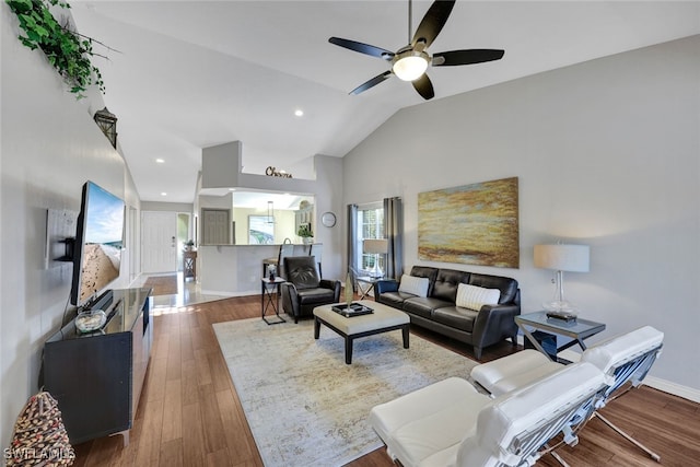 living room featuring dark wood-type flooring, ceiling fan, and lofted ceiling