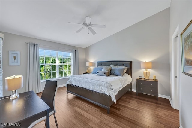 bedroom with ceiling fan, vaulted ceiling, and wood-type flooring