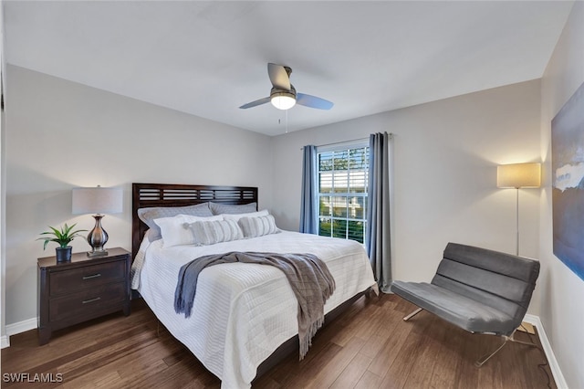 bedroom with dark hardwood / wood-style floors and ceiling fan