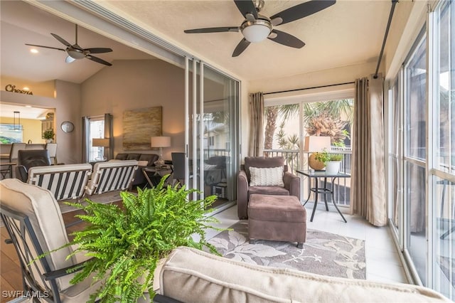 sunroom featuring ceiling fan and lofted ceiling