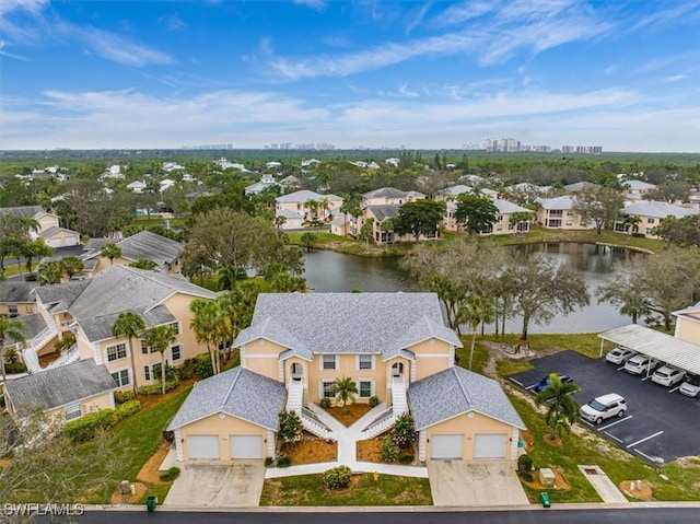 birds eye view of property with a water view