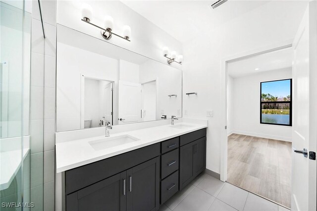 bathroom with tile patterned floors, vanity, and a shower with shower door