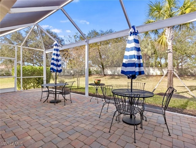 view of patio / terrace featuring a lanai