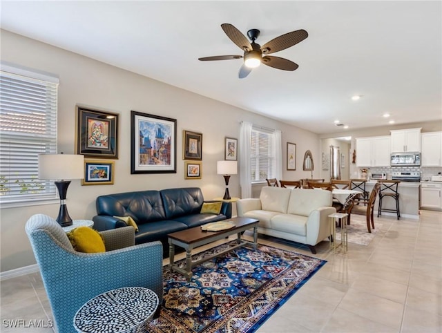 living room featuring light tile patterned floors, baseboards, a ceiling fan, and recessed lighting