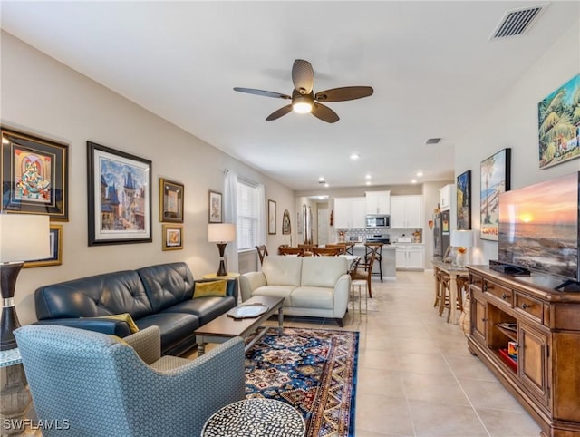 tiled living room featuring ceiling fan