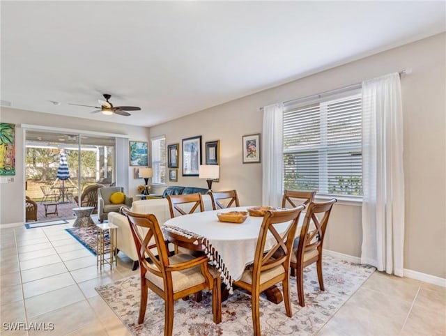 dining area with ceiling fan, baseboards, and light tile patterned floors