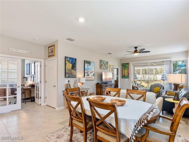 tiled dining room featuring ceiling fan