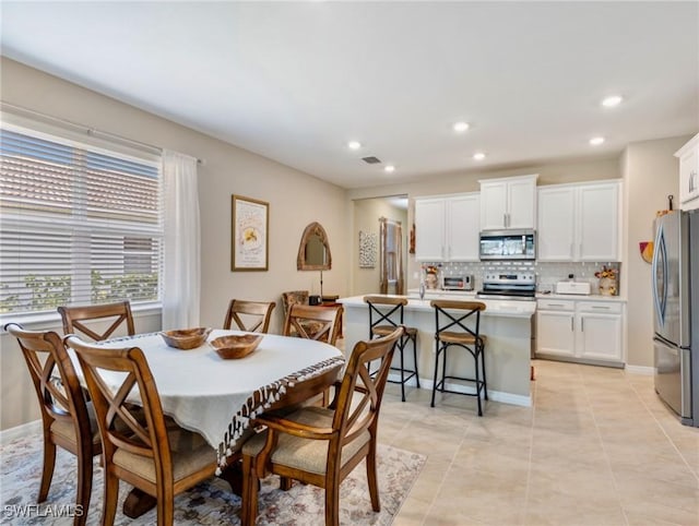 dining room with recessed lighting, visible vents, baseboards, and light tile patterned flooring