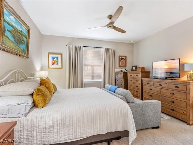 bedroom featuring a ceiling fan and light colored carpet