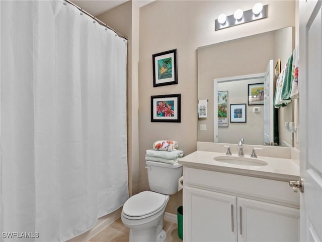 bathroom featuring tile patterned floors, vanity, toilet, and curtained shower