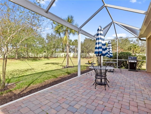 exterior space featuring grilling area and glass enclosure